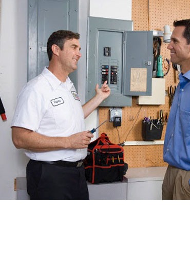 A master electrician providing electrical repair guidance to a fellow commercial electrician.
